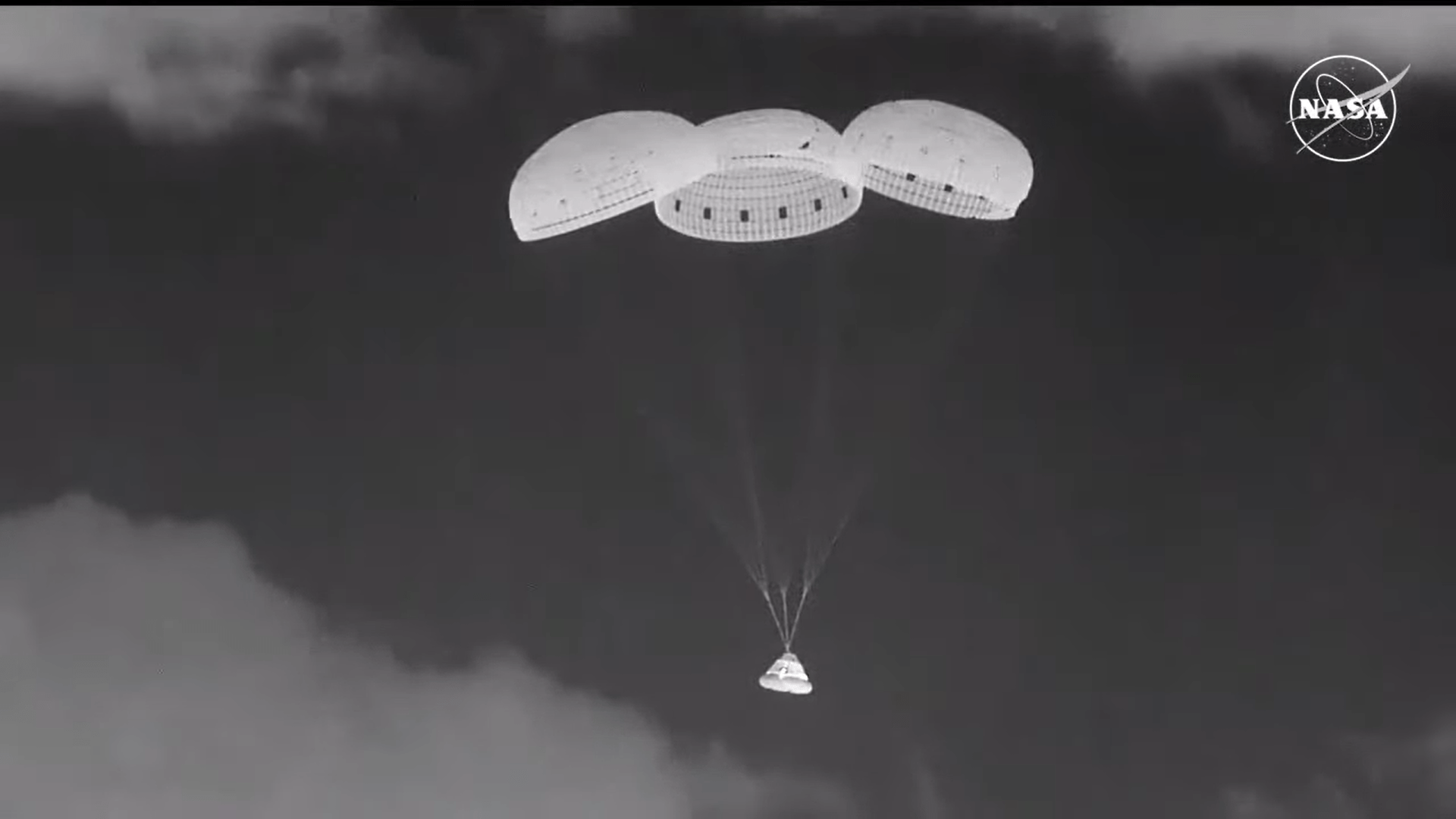 Night vision view of Boeing's Starliner and its parachutes descending to New Mexico.