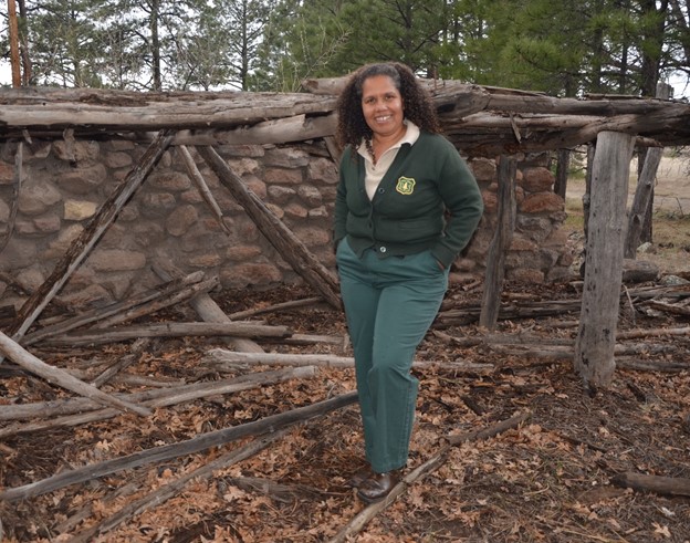 Title: Margaret Hangan - Description: Kaibab National Forest archaeologist Margaret Hangan stands in front of a prehistoric ruin near Williams, Ariz. Photo by Dyan Bone. Credit Kaibab National Forest.